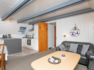 a living room with a couch and a table at 6 person holiday home in Ringkøbing in Ringkøbing