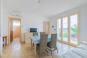 a living room with a table and chairs and a couch at Residence Le Piscine in Nardò