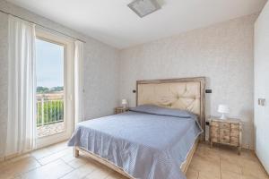 a bedroom with a bed and a large window at Residence Le Piscine in Nardò +107 photos