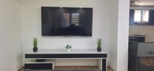 a living room with a tv on a wall at Vila Marjanovic PN in Paraćin