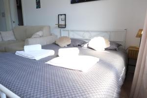 a bedroom with a bed with two pillows on it at Casa Segantini - Panorama Pool Apartment in Riva del Garda