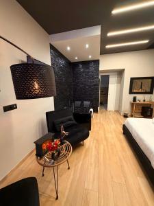 a living room with a bed and a couch and a table at Eterna Suites Roma in Rome