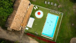 an overhead view of a swimming pool with a frisbee at LE HAMEAU DES ETOILES in Fleurance