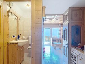 a bathroom with a sink and a toilet at Lagorai Wood Apartment in Telve