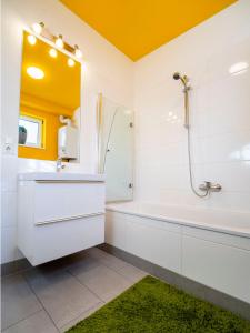 a bathroom with a tub and a sink and a shower at Premium Duplex 2BR for 6 with Balcony near City Museums Metro U3 U2 in Vienna