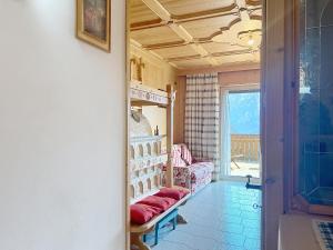 a hallway with a room with a couch and a window at Lagorai Wood Apartment in Telve +38 photos