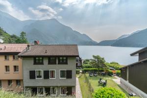 a building with a view of a lake and mountains at Casa Maria in Mezzolago