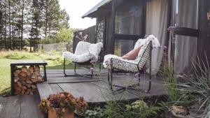 two chairs and a table on a wooden deck at Drewutnia nad Hańczą in Sernetki +20 photos