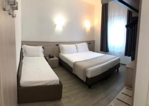 a hotel room with two beds and a window at Hotel Nuova Mestre in Mestre +40 photos