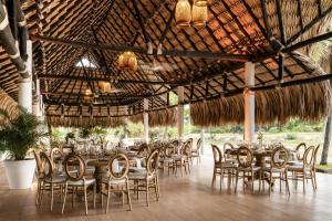 a dining room with tables and chairs in a pavilion at Hilton Cartagena in Cartagena de Indias
