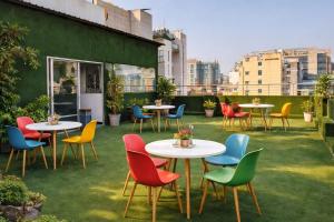 a group of tables and chairs on a rooftop patio at Days Hotel, Baridhara in Dhaka