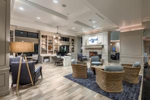 a living room with chairs and a fireplace at Hilton Dallas/Rockwall Lakefront Hotel in Rockwall