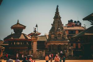 a group of people walking around a group of buildings at Newa Home Bhaktapur in Bhaktapur