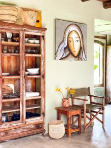 a dining room with a wooden cabinet and a table at Casa Felina in Ilha de Boipeba +52 photos
