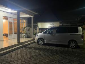 a van parked in front of a house at night at Kivu Breeze Apartment in Gisenyi