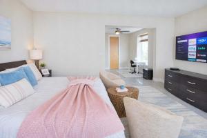 a living room with a large bed and a tv at 3 level luxury Beachlike Pool Killer Sunsets in South Padre Island