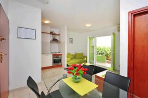 a living room with a vase of flowers on a table at Apartments Beverly in Omiš