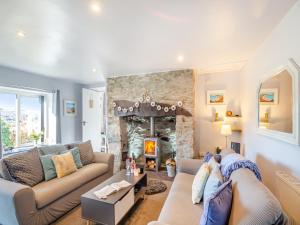 a living room with a couch and a fireplace at Hyfrydle Cottage in Talysarn