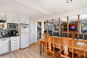 a kitchen and dining room with a wooden table and chairs at Birdcage - King Bed - Walk to CBD in West Hobart