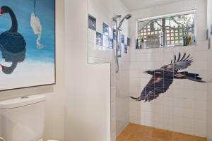 a bathroom with a shower with birds on the wall at Birdcage - King Bed - Walk to CBD in West Hobart
