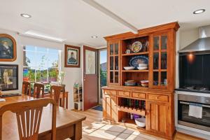 a kitchen with a wooden hutch and a dining room at Birdcage - King Bed - Walk to CBD in West Hobart