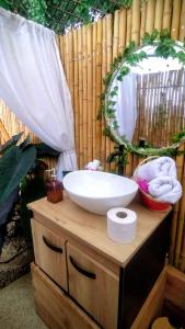 a bathroom with a sink and a mirror at Cabaña Romántica con jacuzzi privado in Icononzo +26 photos