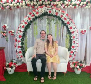 a man and a woman sitting on a couch under an arch at Wooton Peak Resort in Kotagala