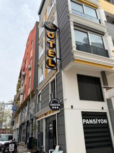 a building with a sign on the side of it at Alpaslan Otel Pansiyon in Antalya +20 photos
