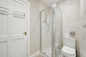 a white bathroom with a shower and a toilet at Glebe House in Uphall +19 photos