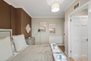 a bedroom with a bed and a white door at Glebe House in Uphall