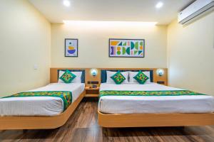 two beds in a hotel room with two at Treebo Grace Stays in Bhubaneshwar +33 photos