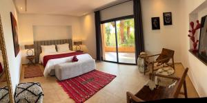a bedroom with a bed and a large window at villa Bidouane in Marrakesh +32 photos