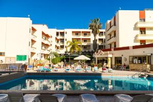 a swimming pool in front of a hotel at Quadruple Room 3629 in St. Paul's Bay