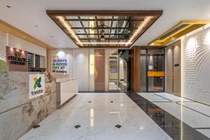 a lobby of a building with a marble floor at Treebo Grace Stays in Bhubaneshwar