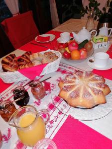 a table with bread and fruit on a table at Masoe des Chatards in Neuilly-le-Réal