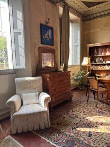 a living room with a chair and a dresser at adagio b&b in Faenza