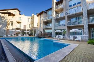 a swimming pool in front of a building at Sea Point By D&G in Carilo