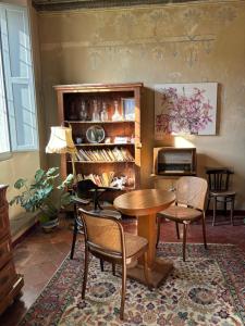 a room with a table and chairs and a desk at adagio b&b in Faenza +1 photo
