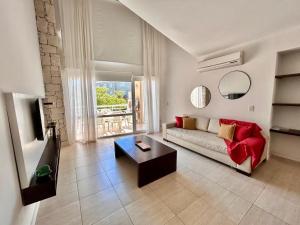 a living room with a couch and a table at Sea Point By D&G in Carilo