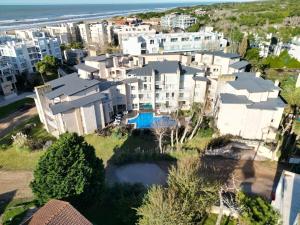 an aerial view of a large apartment building next to the beach at Sea Point By D&G in Carilo