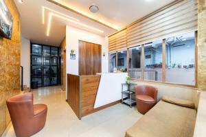 a room with a table and chairs and a counter at Grace Apart Hotel @Kochi in Cochin