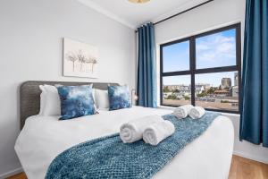 a bedroom with a bed with towels on it at Cape on Popham 21B in Bloubergstrand