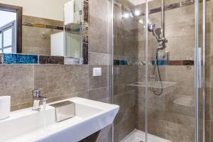 a bathroom with a sink and a shower at NURAS - Joia city center in Alghero +25 photos