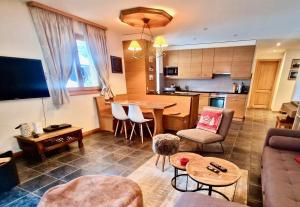 a living room with a couch and a table at Le Charme 1, Morgins in Morgins
