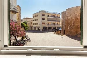 a view of a courtyard from a window of a building at NURAS - Joia city center in Alghero