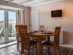 a dining room with a wooden table and chairs at Uk47758 - Horseshoe Cottage in Launceston
