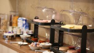 a counter with two trays of food on it at Days Hotel, Baridhara in Dhaka