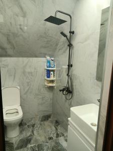 a bathroom with a white toilet and a sink at Dom Semya Gusar in Qusar +70 photos