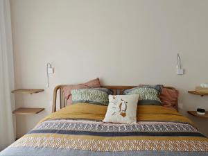 a bedroom with a bed with two pillows at Au Bon Cap in Hervelinghen
