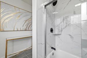 a bathroom with a shower with a marble wall at Dormont, Pittsburgh !A Spacious and Modern Private Bedroom with Shared Bathroom in Pittsburgh +19 photos